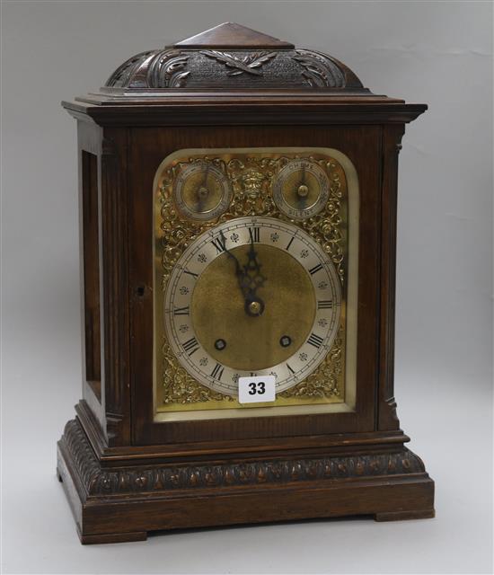 A carved oak mantel clock, with ting-tang chiming movement and brass dial